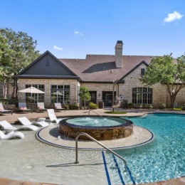 a swimming pool with lounge chairs