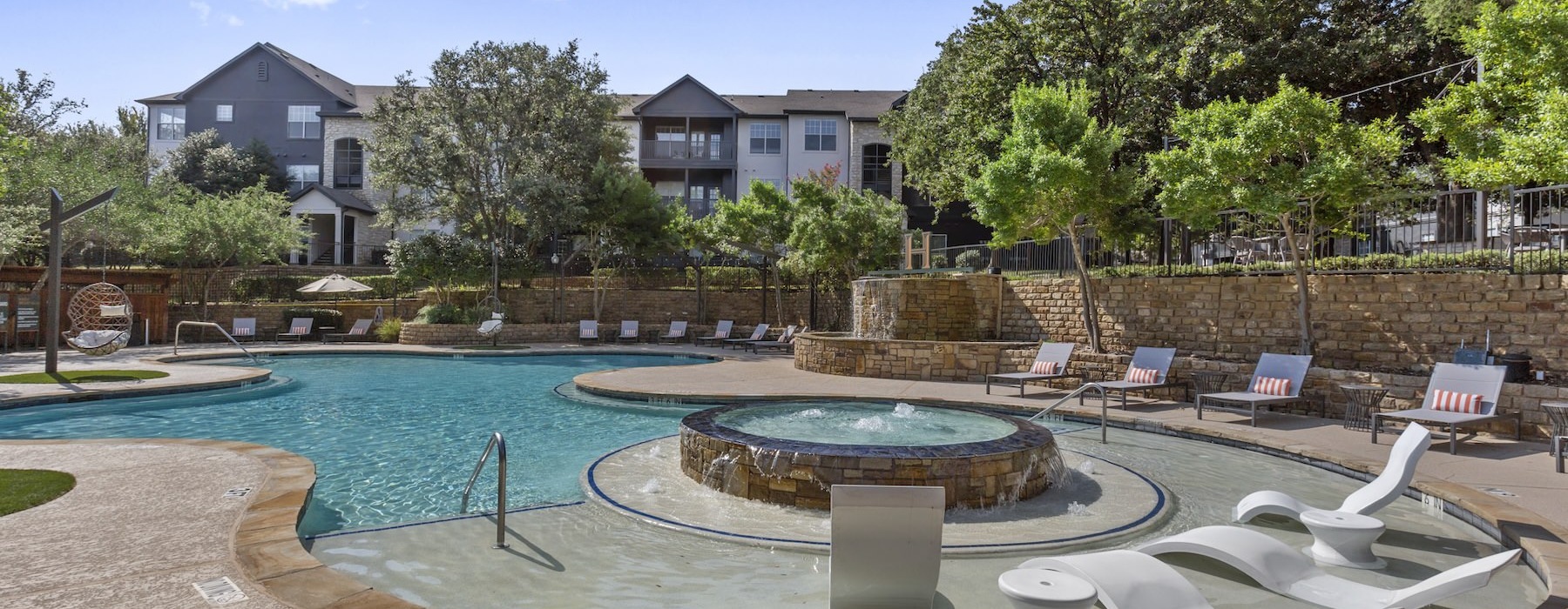 a swimming pool with chairs around it